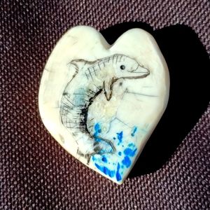 Hand crafted heart with scrimshaw dolphin made from Ivory.